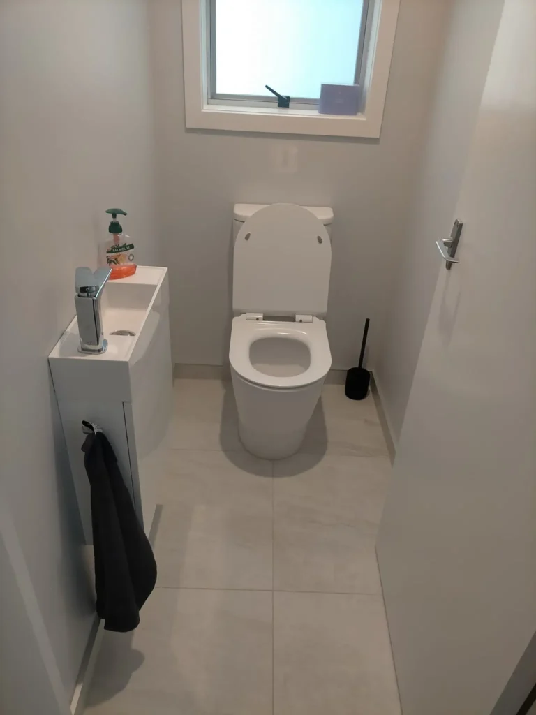Happy Wellington homeowners with completed small bathroom renovations by Bathroom Renovations Wellington.